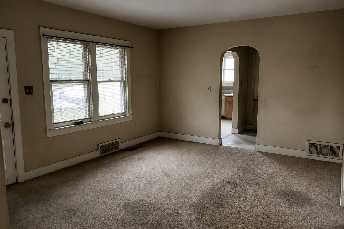 Living room before painting, dated and worn walls